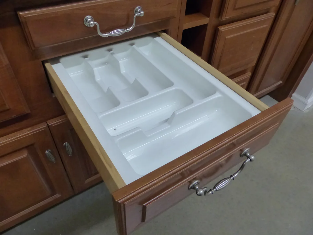 White compartment organizer inside an open kitchen drawer